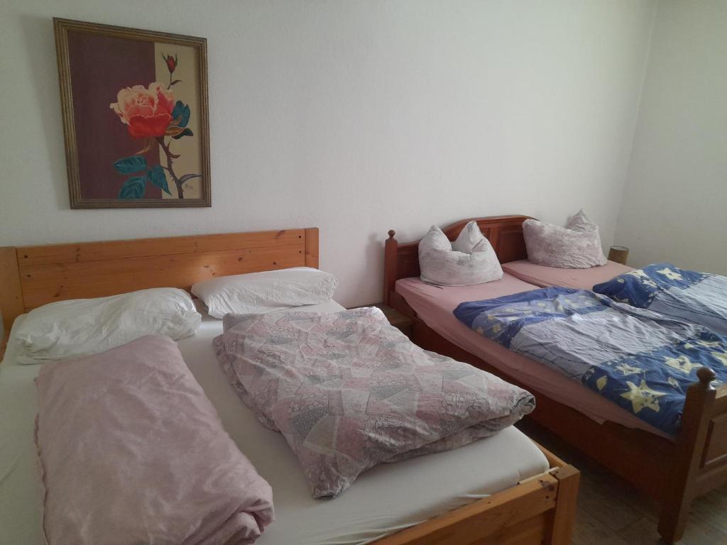 a room with two beds and a picture on the wall at Gasthaus Zur Rose in Malsch