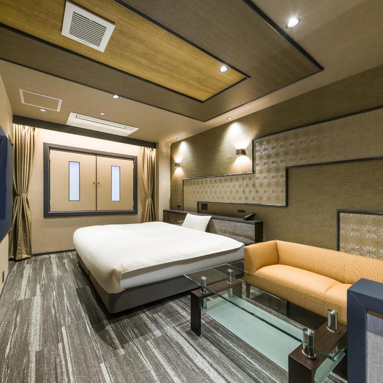 Postel nebo postele na pokoji v ubytování Hotel Noir Blanc