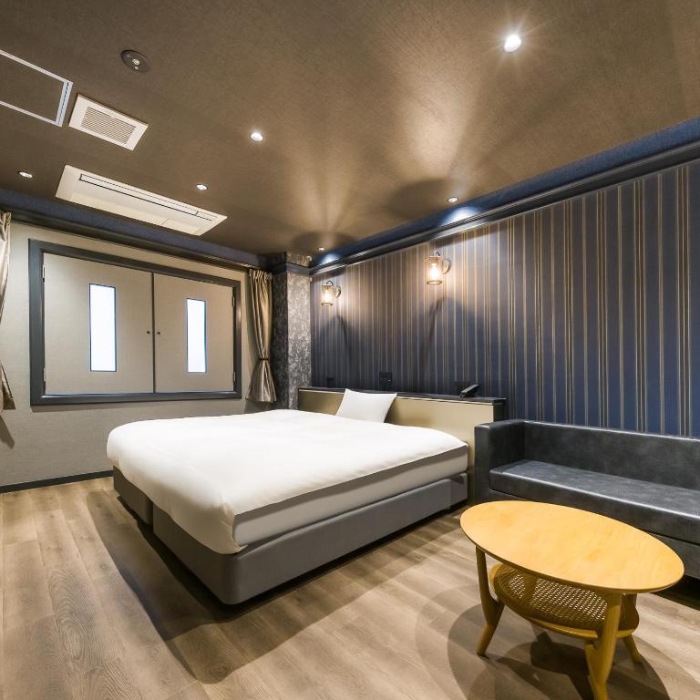 Postel nebo postele na pokoji v ubytování Hotel Noir Blanc