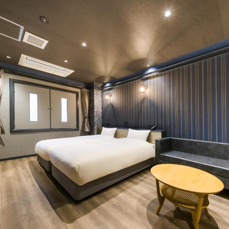 Postel nebo postele na pokoji v ubytování Hotel Noir Blanc