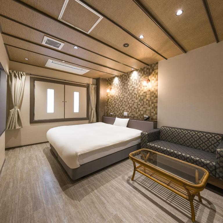 Postel nebo postele na pokoji v ubytování Hotel Noir Blanc