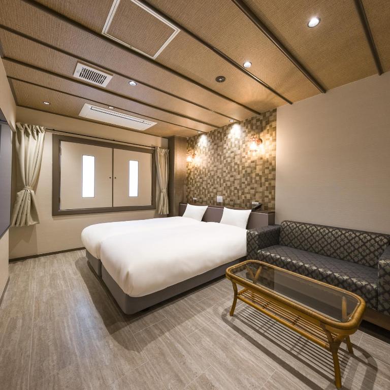 Postel nebo postele na pokoji v ubytování Hotel Noir Blanc