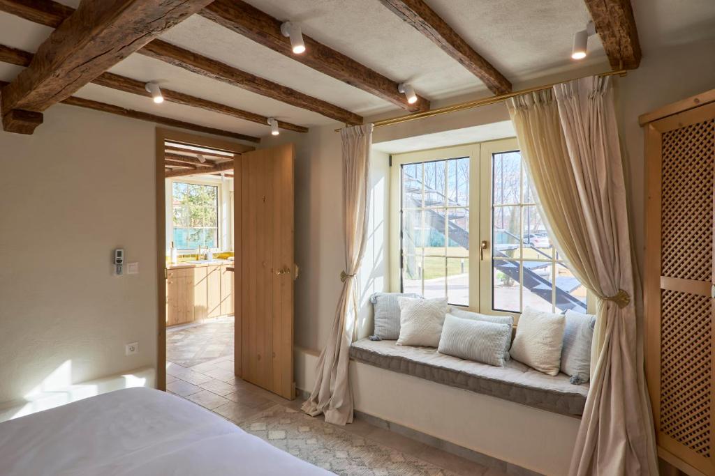 a bedroom with a window seat in front of a window at Villa Alma 1910 Starosel in Starosel