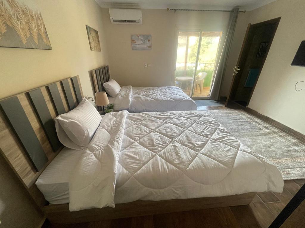 Voodi või voodid majutusasutuse Malek Pyramids Guest House toas