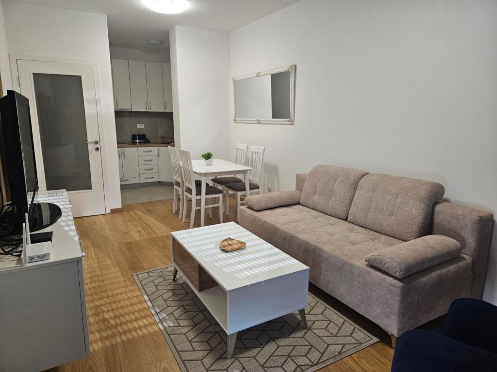 a living room with a couch and a table at Apartment Dora in Banja Luka
