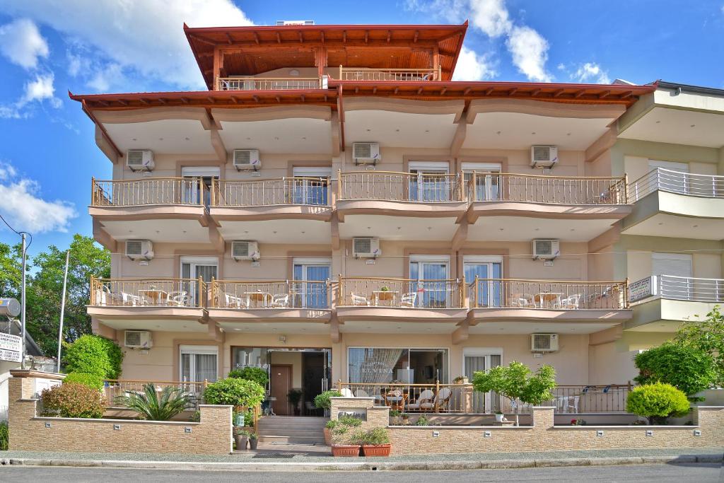 a large building with balconies on it at Εlvina apartments in Leptokarya