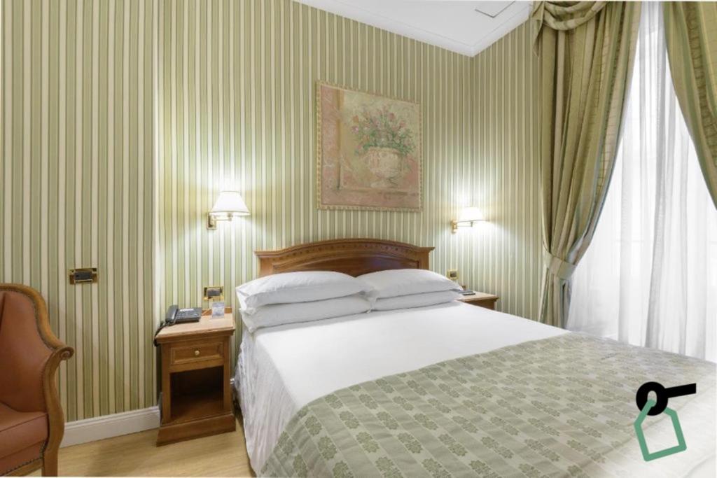 Postel nebo postele na pokoji v ubytování HOTIDAY Room Collection - Roma Porta Pia