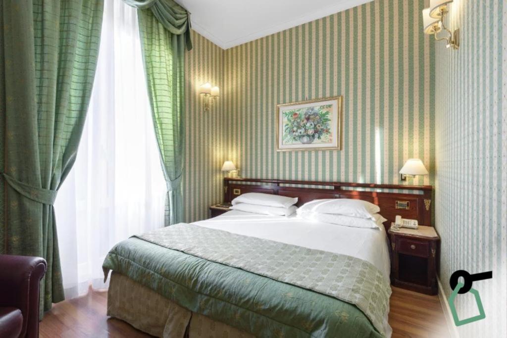 Postel nebo postele na pokoji v ubytování HOTIDAY Room Collection - Roma Porta Pia