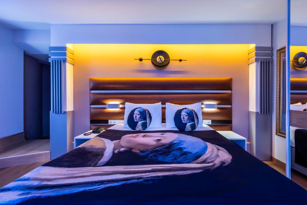 a large bed with a picture of two people on it at Gallery Residence & Hotel Nişantaşı in Istanbul