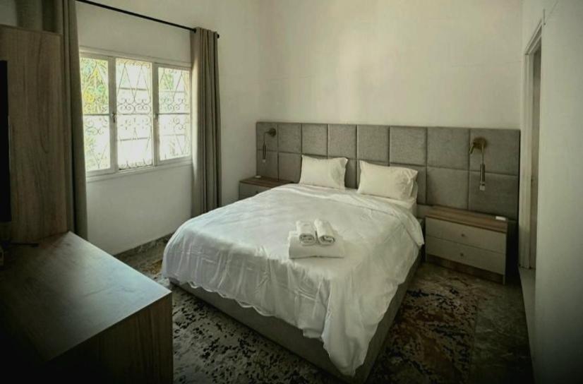 a bedroom with a bed with two towels on it at Guesthouse MALAGUETA INN II in Maputo