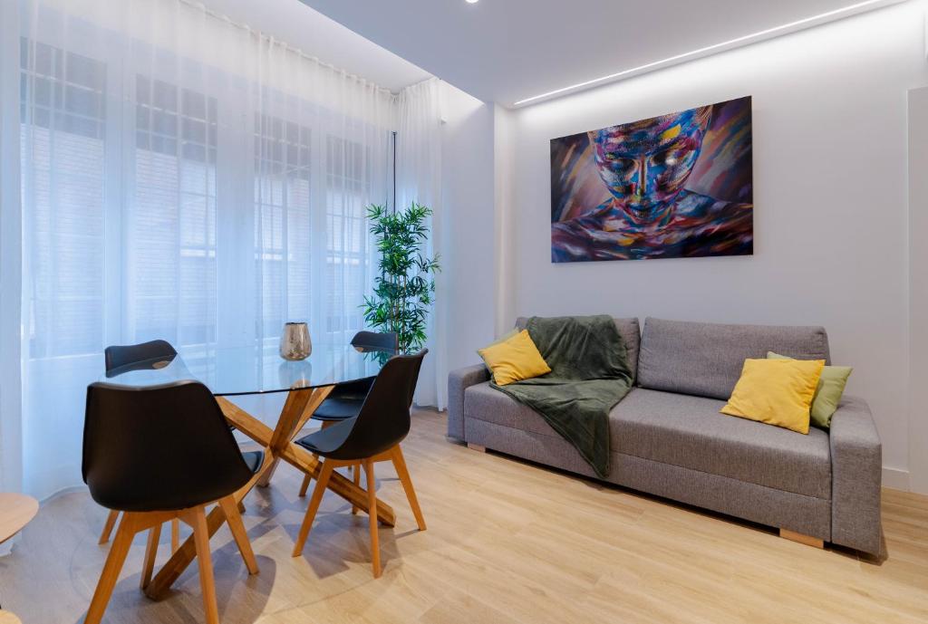a living room with a couch and a table at Apartamentos TriBeCa Centro I in Albacete
