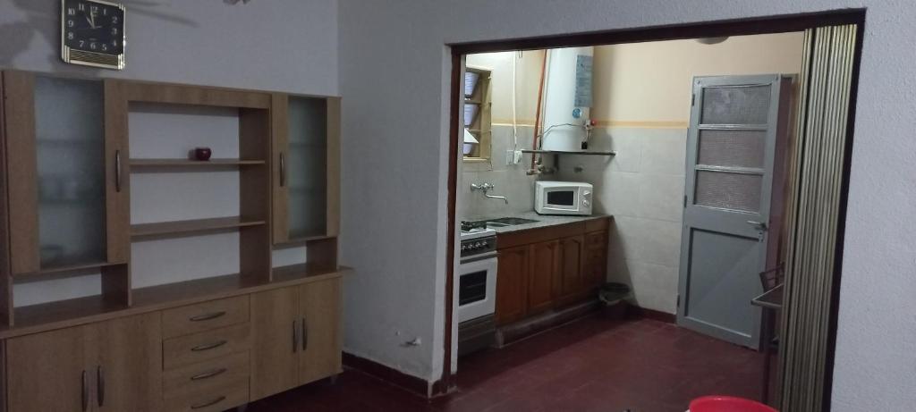 a small kitchen with a stove and a refrigerator at Hause la rioja in La Rioja