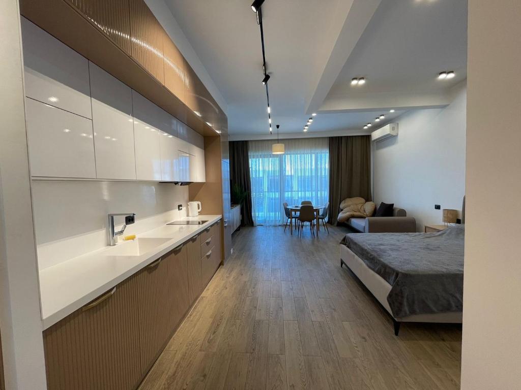 a bedroom with a bed and a kitchen and a living room at Sea Breeze Studio in Baku