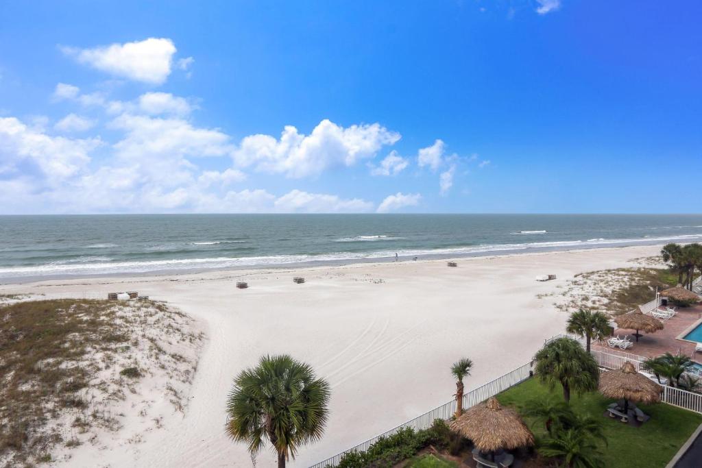 an aerial view of a beach with palm trees and the ocean at Sea Breeze 401 in St. Pete Beach