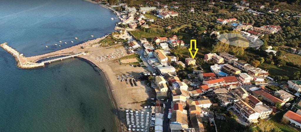 an aerial view of a beach with a yellow arrow at Pitsinis Apartments I in Roda