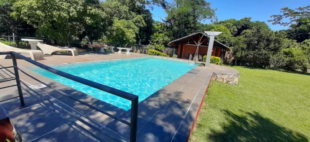 a swimming pool in the backyard of a house at Quinta Los Lapachos de Ypané in Ypane