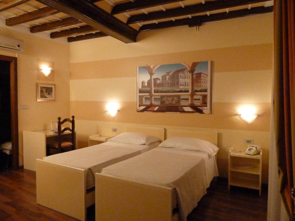 Postel nebo postele na pokoji v ubytování Hotel Antica Dogana