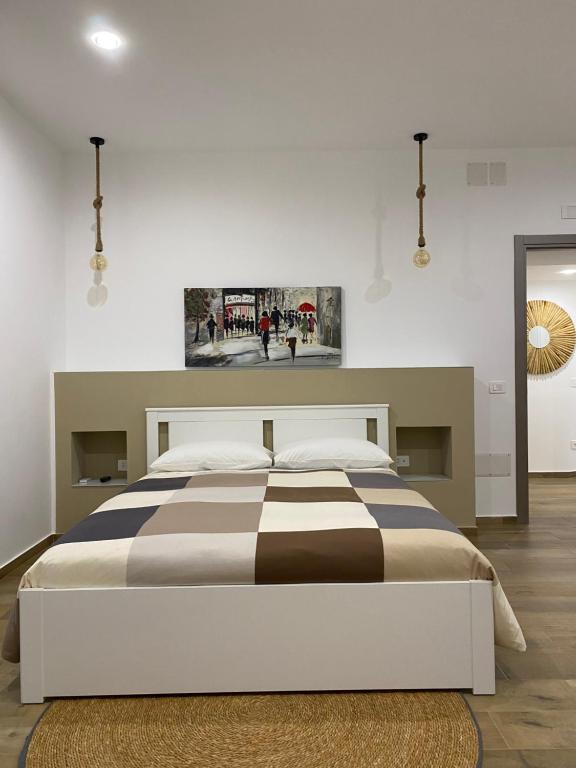 a bedroom with a bed with a black and white blanket at Luma in Caserta