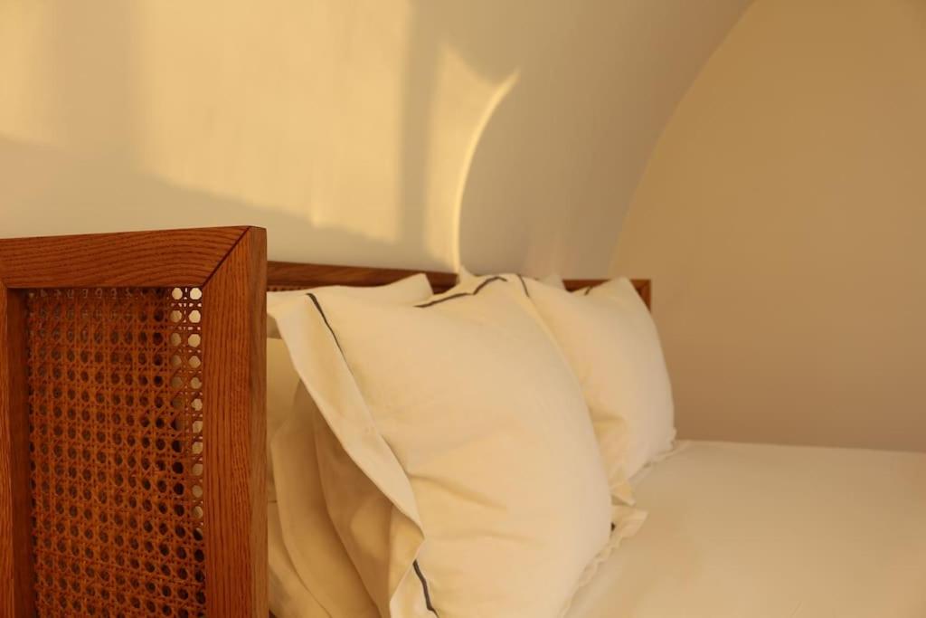 a bed with white pillows and a wooden head board at The View in Antwerp