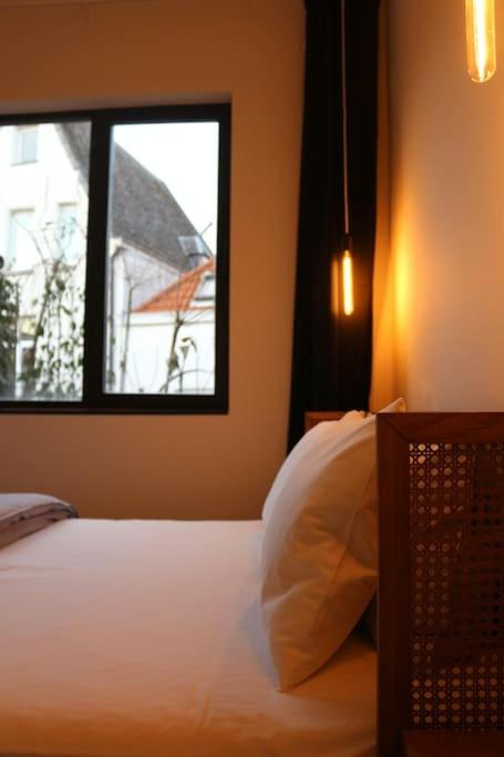 a bedroom with a bed and a window at The View in Antwerp