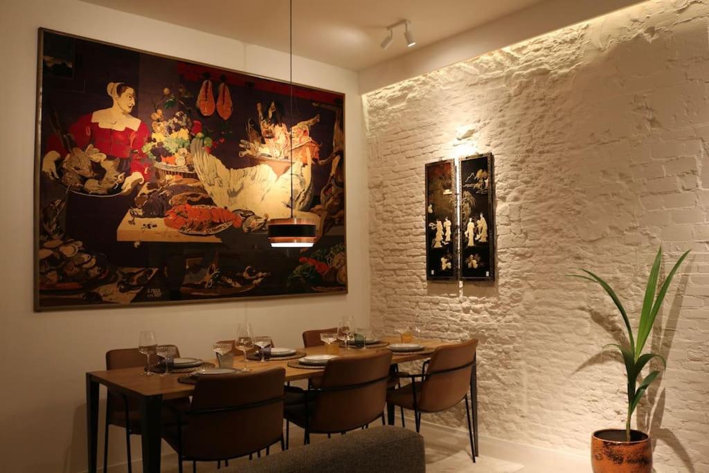 a dining room with tables and a painting on the wall at The View in Antwerp