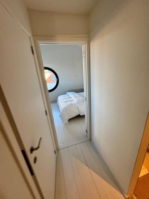 a small room with a bed and a mirror at The View in Antwerp