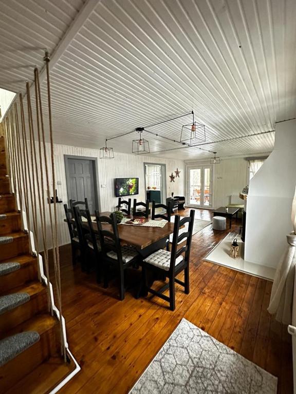 a living room with a dining room table and chairs at Wood House Valiug in Văliug