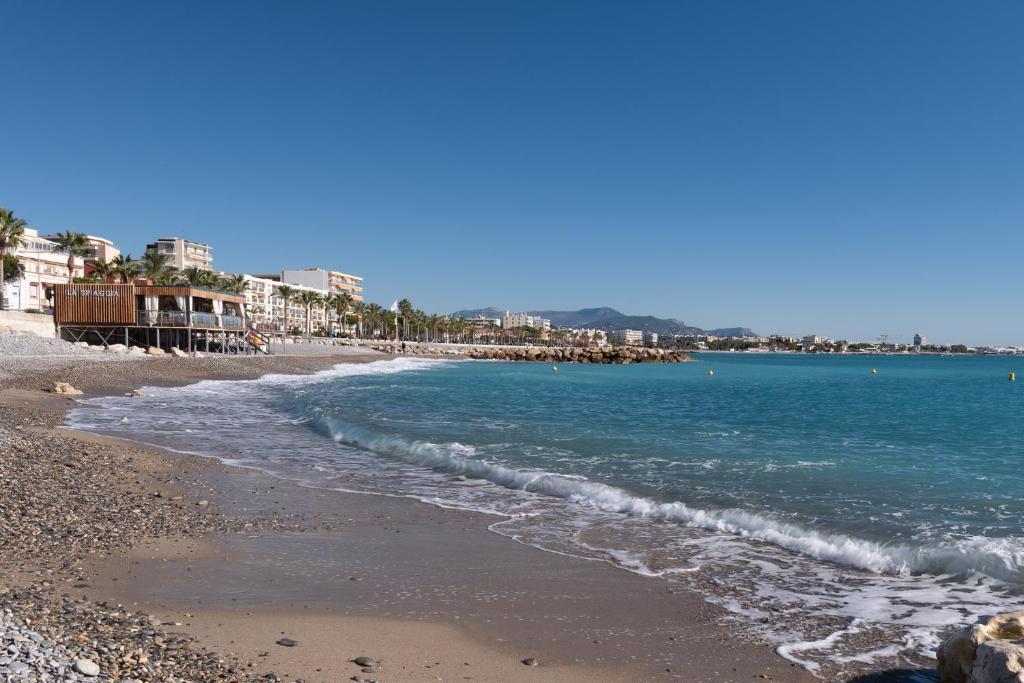 a beach with the ocean and buildings in the background at Studio Cagnes-Sur-Mer, Bord de mer, Côte d'Azur in Cagnes-sur-Mer