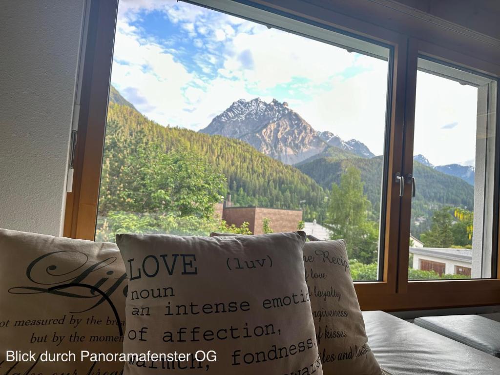 a window with a view of a mountain at Chasa Stefania mit rundum Bergblick und Garten in Scuol