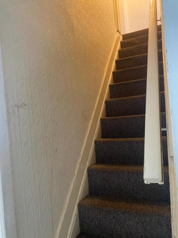 a staircase in a house with a stair case at Portable Single room in Bury