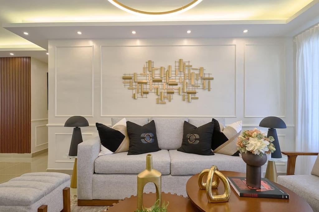 a living room with a couch and a chandelier at Amazing Luxury Apartment near the city center with gym and much more amenities! In Santo Domingo Oeste in Santo Domingo