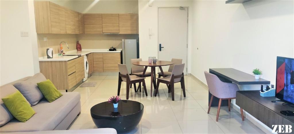 ein Wohnzimmer und eine Küche mit einem Sofa und einem Tisch in der Unterkunft i-City【CASA MILA】~Wifi/Netflix/Parking~7pax in Shah Alam