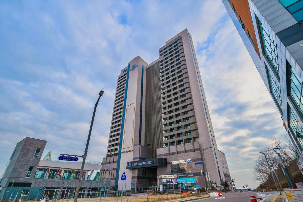 a large building on a city street with a sky at Inchon sky and sea ocean view hotel in Incheon