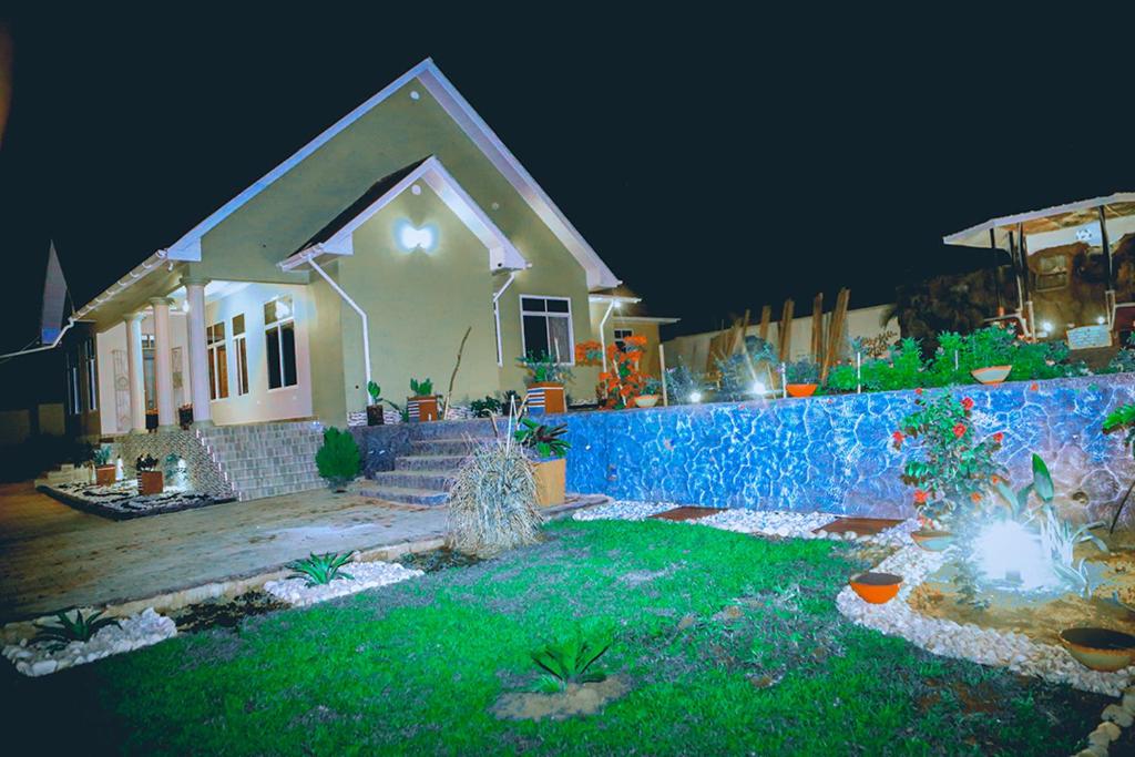 a house with a garden in front of it at night at Hadeb Property in Bukoba