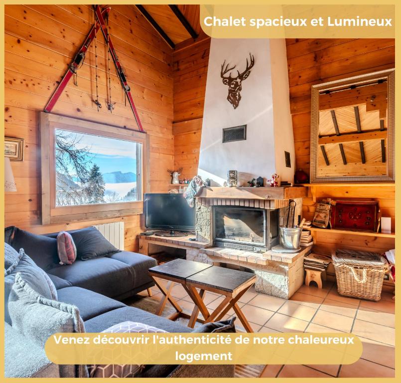 a living room with a couch and a fireplace at Sublime Chalet T5 Les Gets in Les Gets