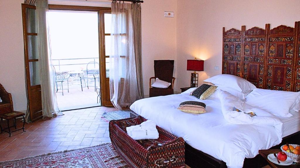 Postel nebo postele na pokoji v ubytování Hotel Podere Conti