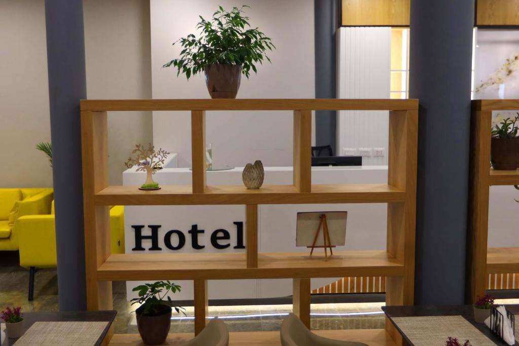 a shelf in a room with plants on it at Metro Hotel Terminal in Tirana