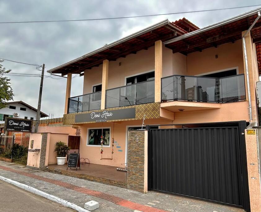 a building with a balcony on the side of a street at Canto dos pássaros. in Balneário Camboriú
