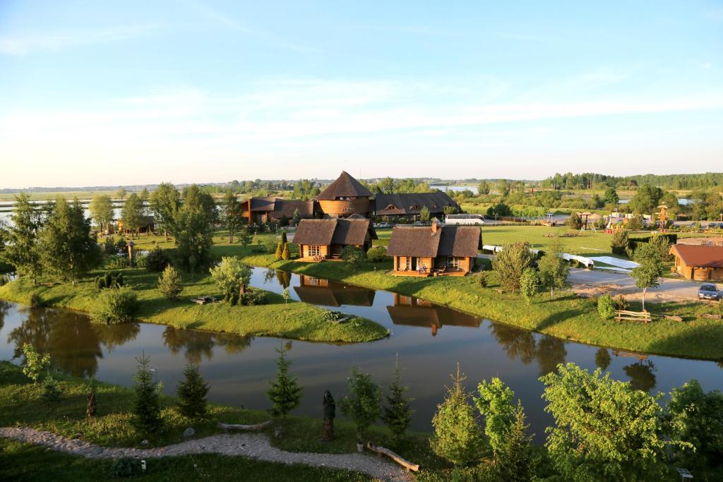 an aerial view of a village next to a river at KARPYNĖ Restaurant & Bed & Breakfast in Gabšiai