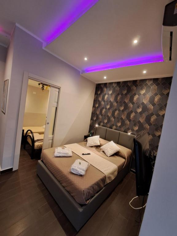 a bedroom with a bed with a purple lighting at Aircraft services rooms in Naples