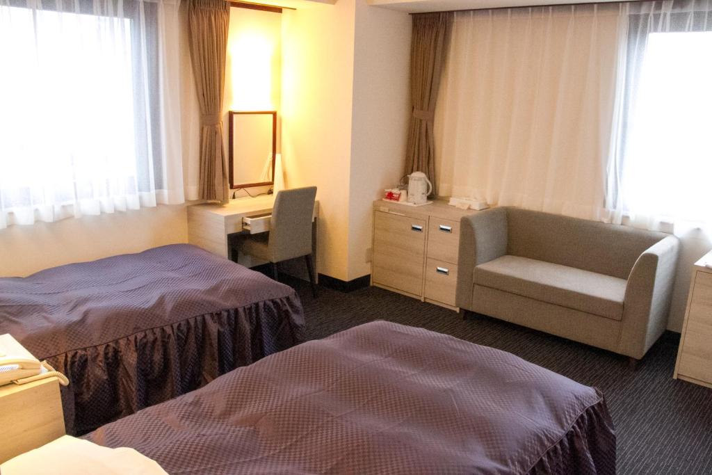 Tempat tidur dalam kamar di Hotel Monteroza Ohta