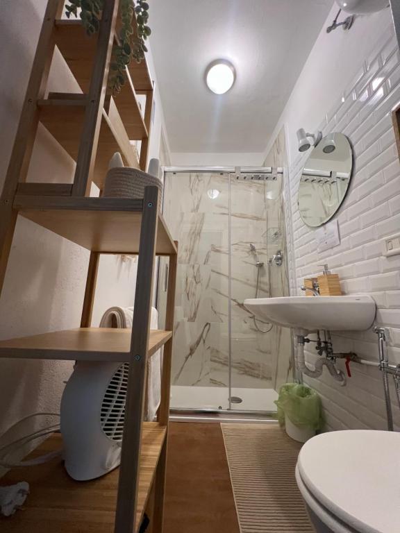 a bathroom with a shower and a toilet and a sink at LOGICO #35 HOME in Bari