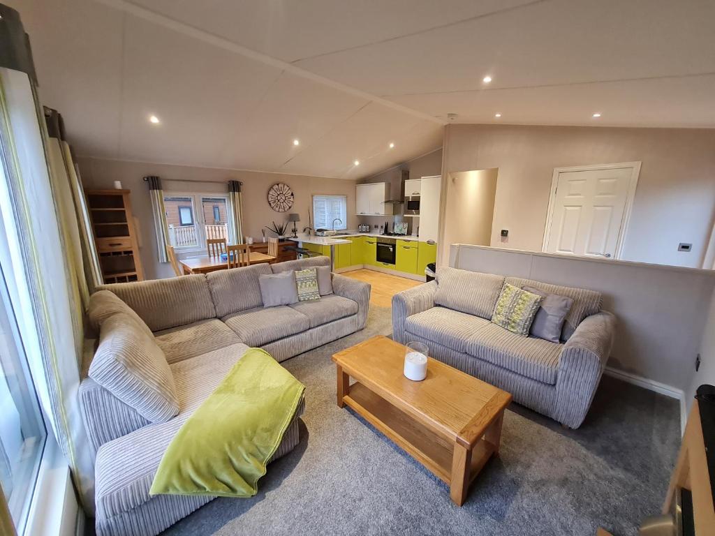 a living room with two couches and a coffee table at Sherwood 33 in Carnforth