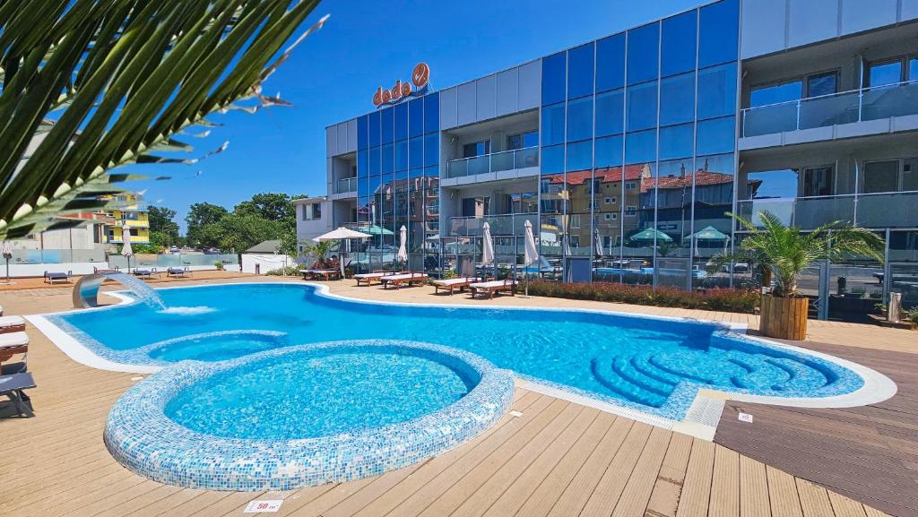 a large swimming pool in front of a building at Dodo Beach Hotel in Kiten