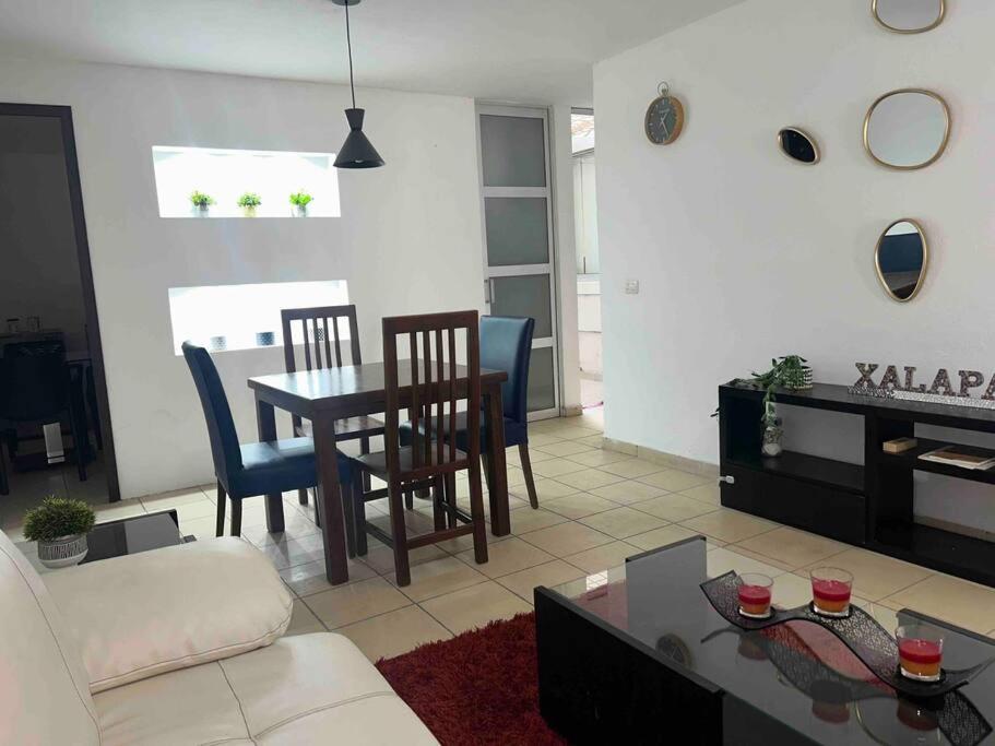 a living room with a couch and a table and chairs at Rinconcito de Paz en Xalapa in Xalapa