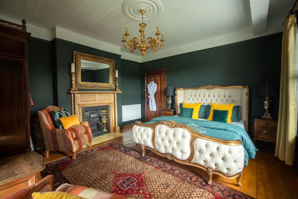 a bedroom with a large bed and a fireplace at House of Brohedyn in Newcastle Emlyn