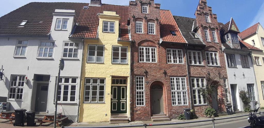a yellow and white building on the side of a street at Ferienwohnung Kontor im Traufenhaus in Lübeck