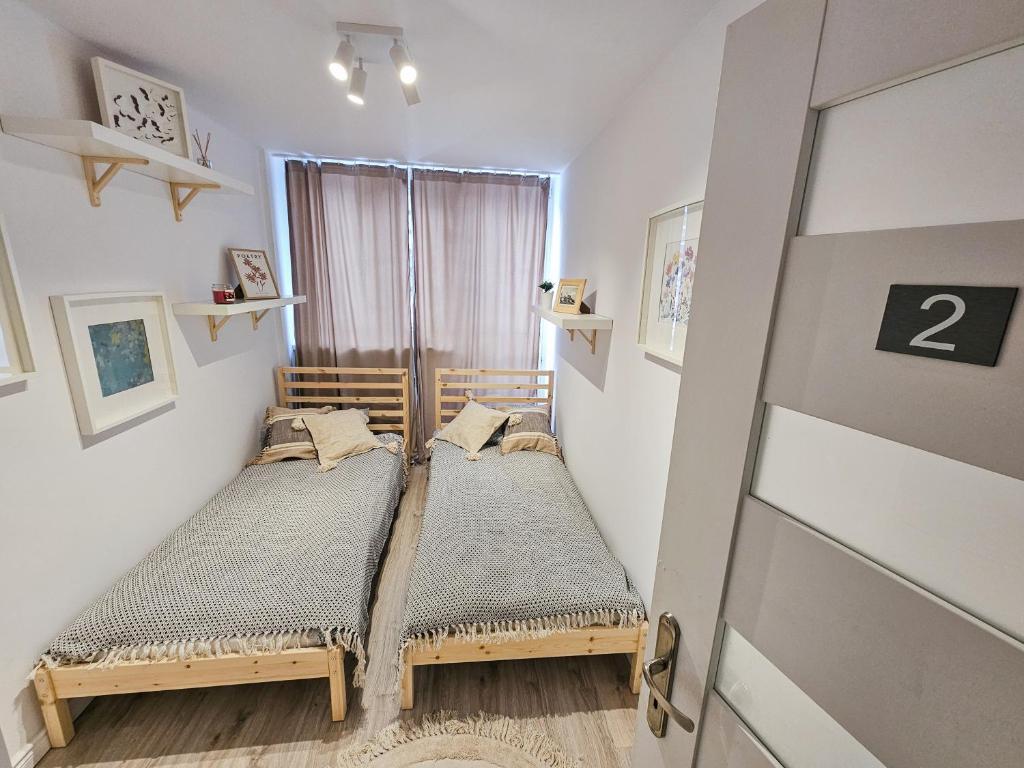 a bedroom with a wooden bed in a room at White Apartment Grzybowska in Warsaw