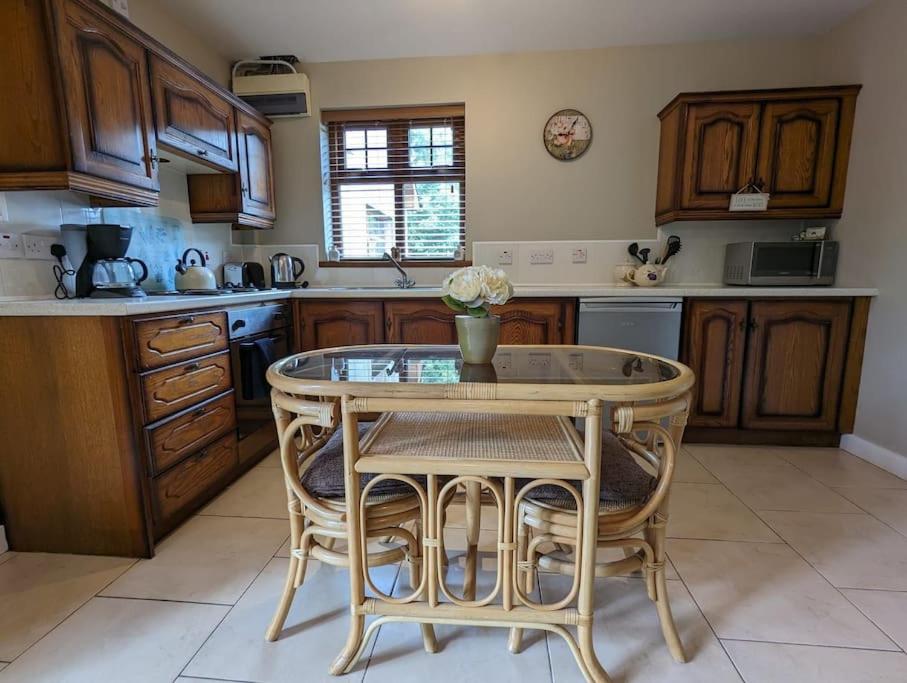 a kitchen with a table and chairs in a kitchen at TeachinTom in Strabane