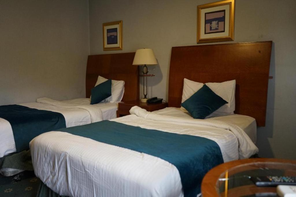 Postel nebo postele na pokoji v ubytování Conord Hotel